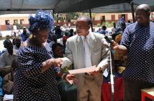 07 Dr. Thomas Sukwa presenting award to the Head Mistress of Brufut Lower Basic School as winners of the World No Tobacco Day 2012