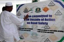 The Minister of Information signing road safety commitment