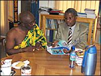 Dr. Saweka shares documents with Osabarima.