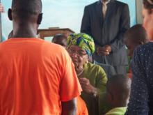 President Sirleaf encouraging six children who lost their parents to Ebola. Their parents were members of the church.