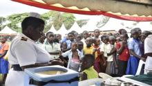 Girls line up to receive the HPV vaccine during the launch