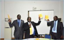 Mr. Steven Aisu left, Hon. James Mutende center and Dr. Joshua Mutambi launch the National Accreditation Policy, 2014