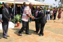 The Group Village Headman Kamenyagwaza (left) bids farewell to the Honorable Minister Mr Atupele Muluzi, MP, after the launch ceremony of the National Alcohol Policy  