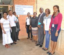 The WHO Representative Dr. Custodia Mandlhate (centre) with the head of the virology laboratory, Dr. Mwaka Monze and WHO staff members