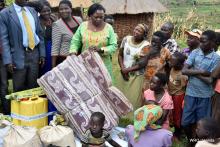 The Minister of State for Primary Health Care Hon Sarah Opendi handing over the Solidarity Package to the family of the first confirmed case.