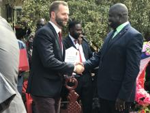 His Excellency Ambassador Alan Hamson, receiving awards from the Governor of Budi State in Yambio.