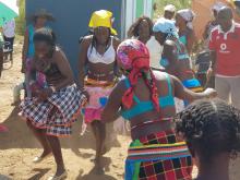 A traditional group celebrating the handing over of the newly constructed toilet for their community