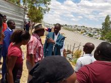 Minister of Health and Social Services Dr Benhard Haufiku talking to Mr Lion Kahimise from the City of Windhoek during the his tour to Havana Informal Settlement