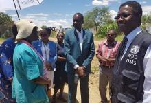 WHO Country Representative with the Minister of Health and UNFPA Country Representative Ms Denia Gayle listening to a community leader in Havana settlement