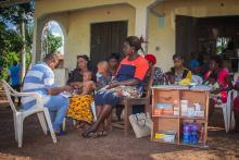 Mrs Ogbaije a corp assessing a sick under-five child