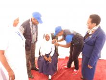 WHO staff vaccinating a girl during the occasion.