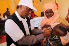 WHO Colleague making marker after vaccinating a child during the launching of mOPV2 vaccination