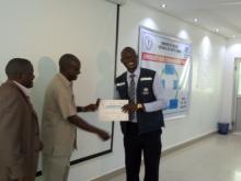 Dr Atem Director General handing over certificates