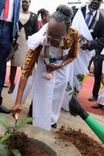 Dr Moeti planting a mango tree at the entrance of the PHEOC.