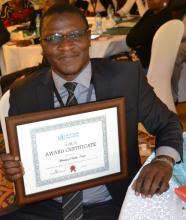  Dr Collins Tabu, head of the National Immunization and Vaccines programme appreciates the MNTE certificate