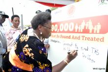 Dr Joyce signs onto the commitment board, commiting to ending TB by 2030