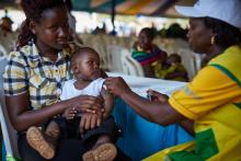 Baby Elian, first baby to be vaccinated with mom Noreen and a nurse