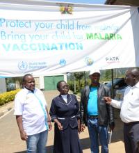 Partners and health workers consult at a vaccinating hospital in Kakamega County following the official launch