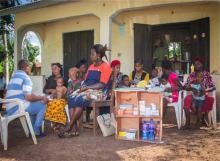 Community health worker treating sick children in the community.