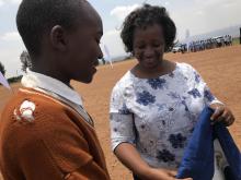 Dr Kasonde Mwinga awards a young student who successfully answered to a public quizz