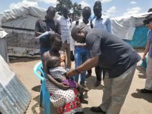 WHO team inspecting a child with a suspected case of acute flaccid paralysis in Rajaf, South Sudan.