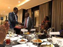 Minister of Health, Honourable Kwaku Agyeman-Manu presenting a gift to Dr Kaluwa