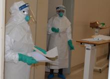 Isolation facility staff at work in complete PPE