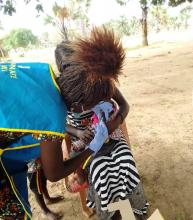 Health workers adminsters vaccination against measles during a campaign in Aweil