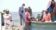 Fishermen on arrival at Kasensero Landing site waiting for guidance from the COVID-19 response team before fully disembarking   