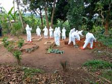 The burial teams preparing to bury a dead person