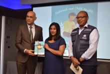 An expectant mother receiving a copy of the MCH Handbook from Dr Hon k. K. Jagutpal, Minister of Health and Wellness in the presence of Dr L Musango, WHO Representative in Mauritius