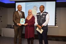 An expectant mother receiving a copy of the MCH Handbook from Dr Hon k. K. Jagutpal, Minister of Health and Wellness in the presence of Dr L Musango, WHO Representative in Mauritius