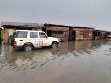 WHO team arrives at the landing site using a flooded road