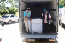The vaccine consignment being taken out of the delivery truck