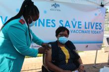 The WHO Health System Strengthening Officer receiving the vaccine