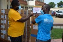Dr. Julius Monday, WHE Team Lead and Mr. John Dogba, National Laboratory Officer inspecting supplies during the donation ceremony