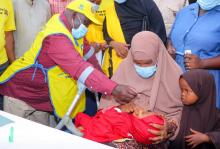 National immunization ambassador Harold Kipchumba vaccinates a child during the national launch of the polio campaign. Over 3 million under-five children are targeted for the May 22-26 response 