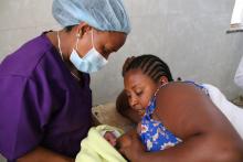 A midwife assists a mother that has just delivered at Mekelle Hospital breastfeed her baby