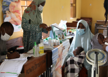 Aisha Yau and two of her children receiving medical consultation