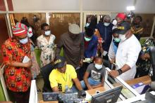 The UN RC Mr Kallon (middle) the WHO Representative (First left) and other dignitaries briefed on the process of enrolment at the Anambra State Health insurance Scheme. Photo: WHO/Ochemba