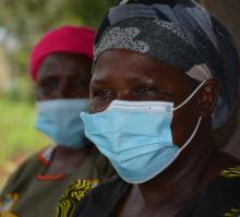 Julia Atieno, right, a community health volunteer who supports families to sustain their health 