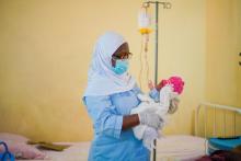 Hannatu Ishiaq, Head of Nursing Unit, Kwali General hospital at the neonatal ward with a newborn.