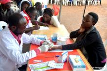 Health worker tests a community member for HIV in Luweero District