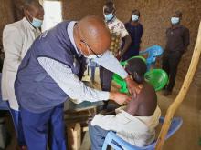 Dr David Rotich offers a helping hand in a vaccination site in Kakamega County