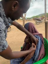Wajir County health workerl vaccinates a member of the nomadic  community in an outreach site