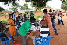 A health worker  administers a dose of COVID-19 vaccine