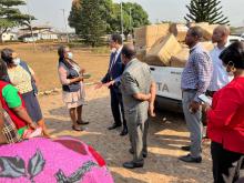 WHO staff handing over health intervention materials to ISTH