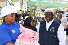 WR a.i. Dr. Zabulon Yoti posing with a parent and child who attended the launch event