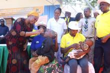 Honourable Minister for Health, Ummy Mwalim giving polio drops to a child at the launch event