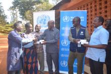District Commissioner handing over a chlorine tester to a representative from the beneficiary CWBSOs
